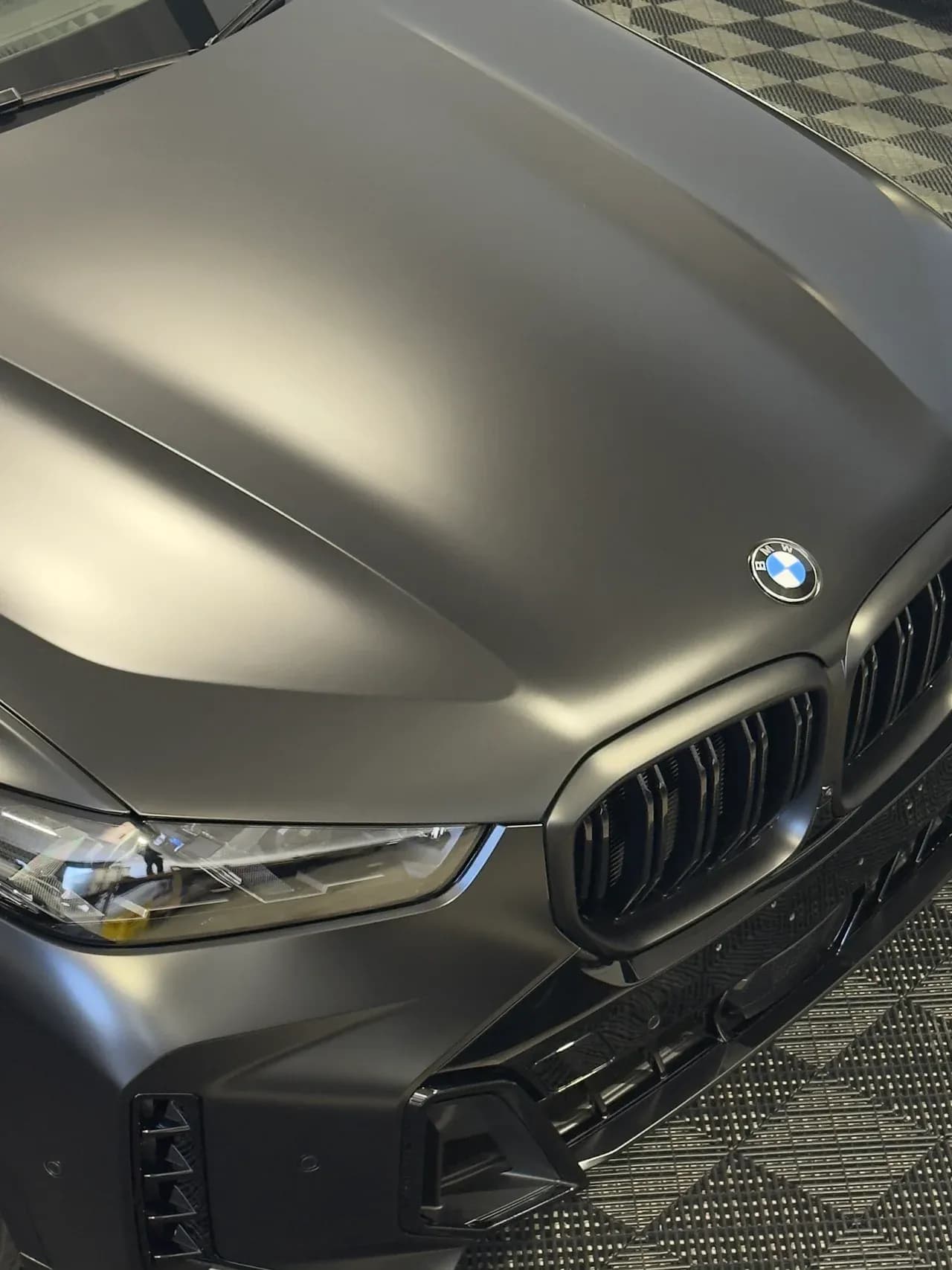 Matte colour change wrap on a BMW X5, front detail