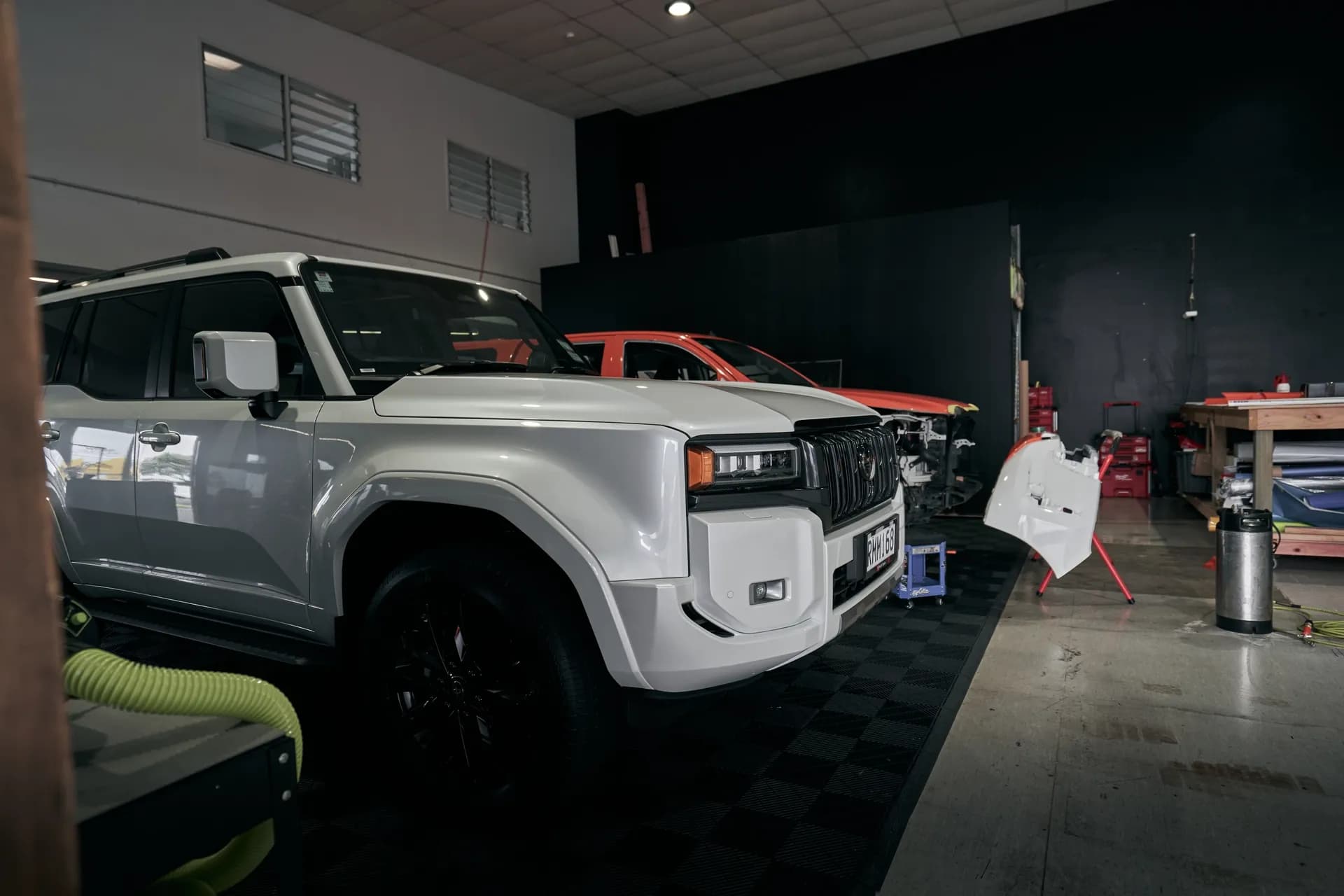 Vehicles inside the Wrap Culture workshop in Mount Maunganui